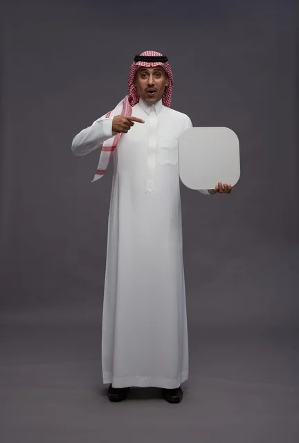 Saudi Man Pointing at Blank Board in Studio