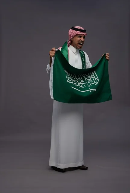 Saudi Man Holding Saudi Arabia Flag in Studio