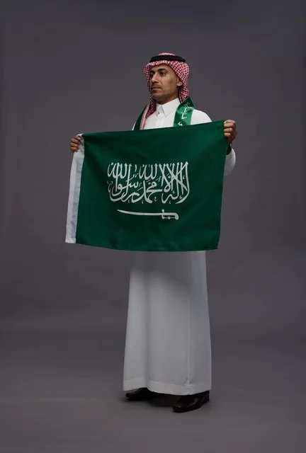 Saudi Man Holding Saudi Arabia Flag in Studio - Photo