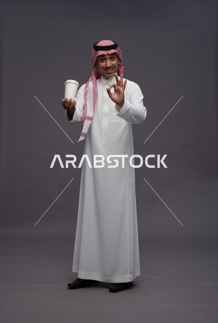 Saudi Man in Thobe Holding Coffee Cup on Grey Background