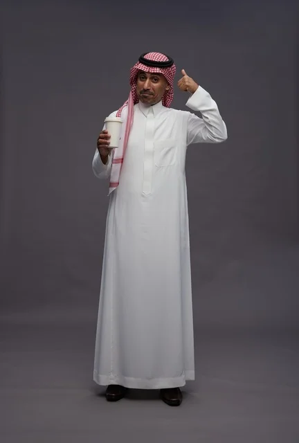 Saudi Man in Thobe Holding Coffee Cup Studio Portrait