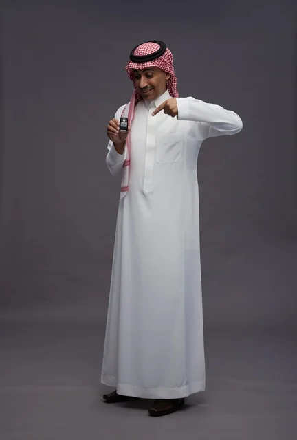 Saudi Man in Traditional Thobe Holding Car Key