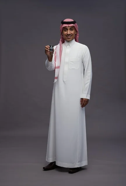 Saudi Man in Traditional Thobe Holding a Car Key
