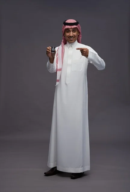 Saudi Man in Traditional Thobe Holding Car Key
