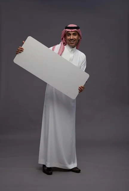 Saudi Man Holding Blank White Board in Studio Shot