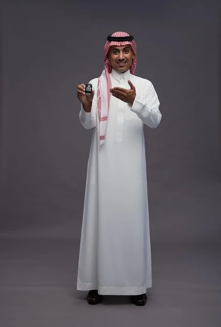 Saudi Man in Traditional Thobe Holding Car Key