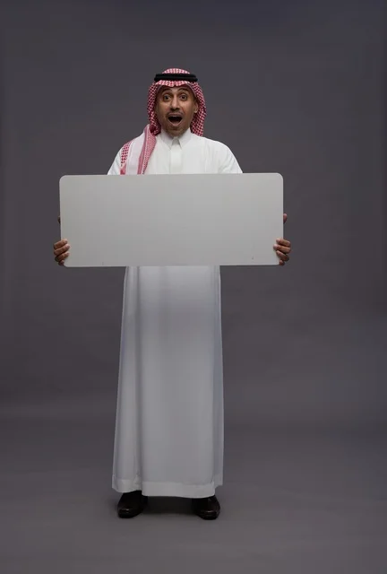 Saudi Man Holding Blank Board with Surprised Face