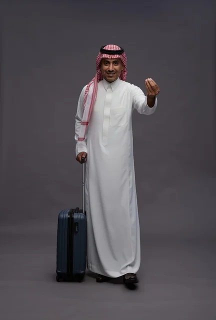 Saudi Man in Traditional Thobe with Travel Suitcase