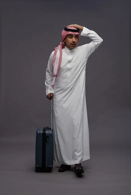 Saudi Man with Suitcase Expressing Confusion