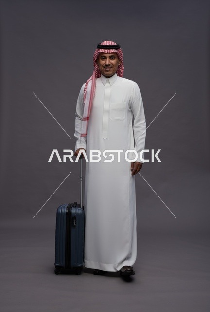 Saudi Man in Traditional Thobe with Travel Suitcase