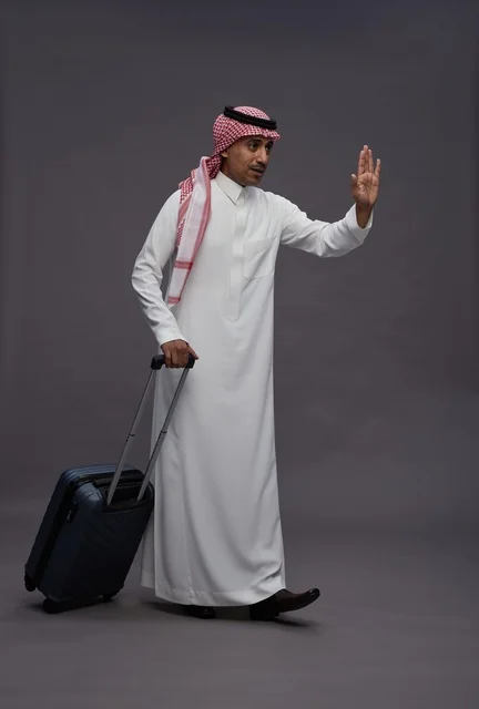 Saudi Man in Traditional Thobe with Travel Suitcase