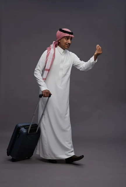 Saudi Man with Suitcase Making Hand Gesture