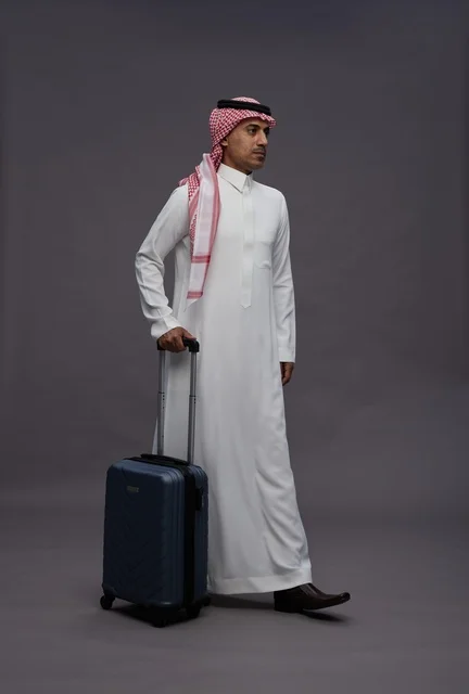 Saudi Man in Traditional Dress with Suitcase