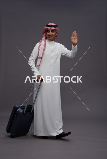 Saudi Man in Traditional Thobe Walking with Suitcase