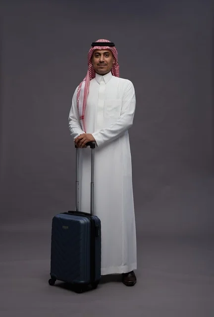 Saudi Man in Traditional Thobe with Travel Suitcase