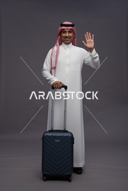 Saudi Man in Traditional Dress with Suitcase Waving