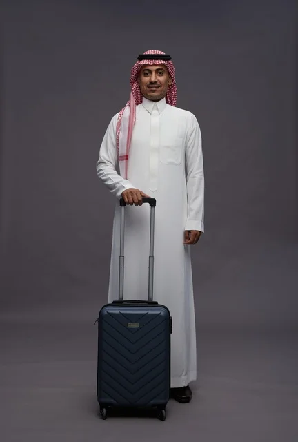 رجل سعودي بالزي التقليدي مع حقيبة سفر