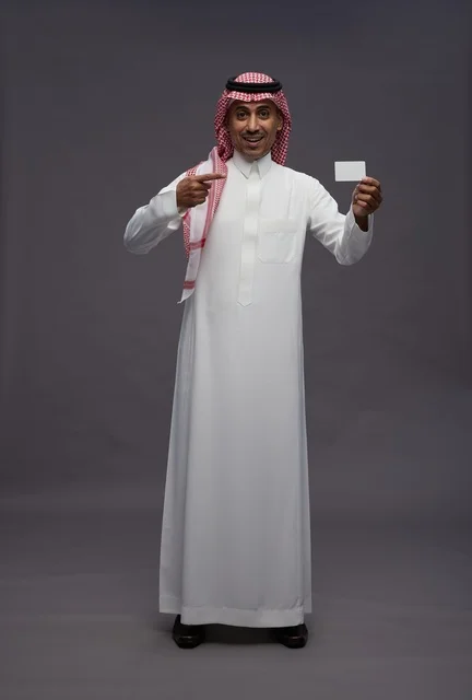 Saudi Man in Traditional Thobe Holding Credit Card