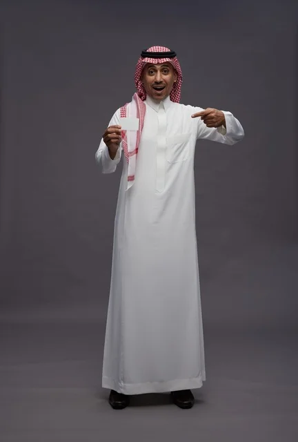Saudi Man in Traditional Thobe Holding Credit Card