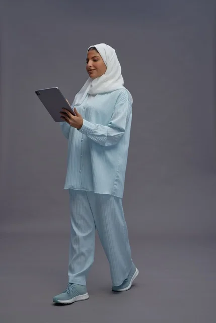 امرأة سعودية بزي كاجوال محتشم تستخدم تابلت