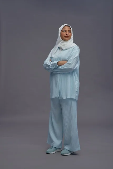 Saudi Woman in Modest Casual Outfit on Grey Background