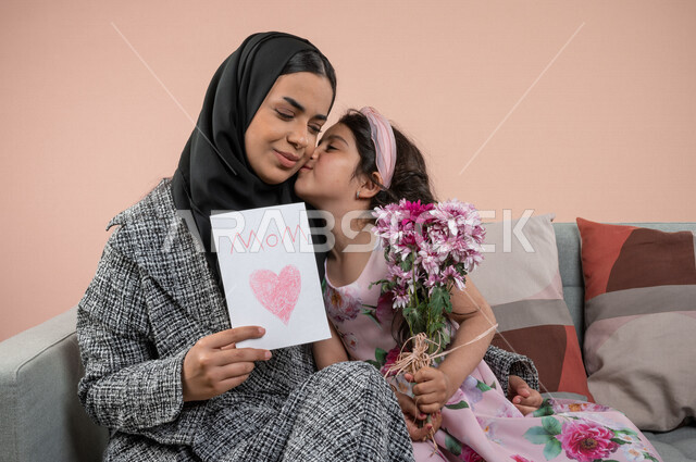 Portrait for an Arab Gulf for an Arab Gulf accept her mother, the beautiful roses and a greeting card for her parents show joy and happiness, Mother's Day gift, Happy day, birthday, holidays and happy events