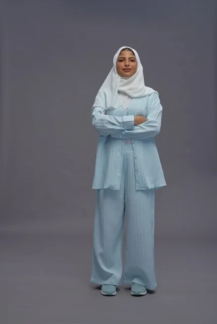 Saudi Woman in Modest Casual Outfit on Grey Background