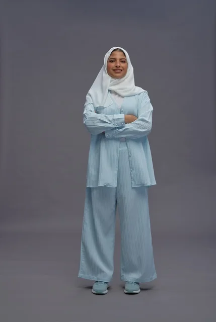 Saudi Woman in Modest Casual Outfit on Grey Background