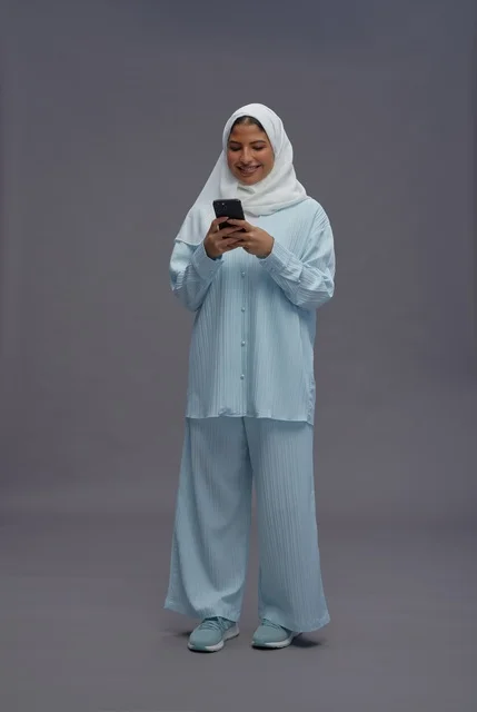 Saudi Woman in Hijab Using Smartphone Studio Portrait