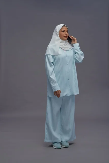 Saudi Woman in Hijab Talking on Smartphone in Studio