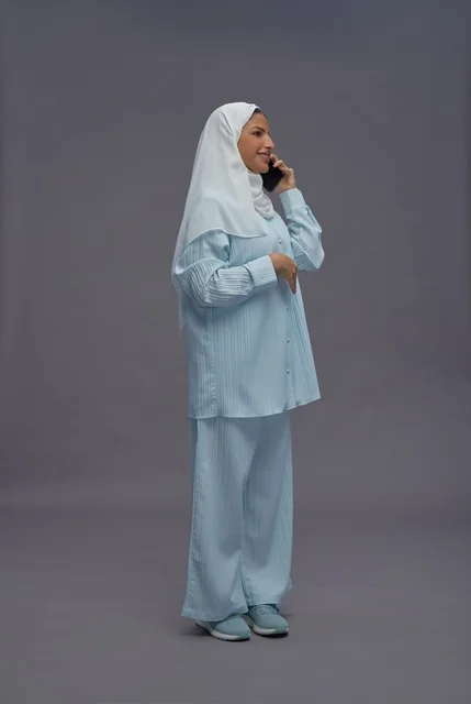 Saudi Woman with Smartphone in Studio Setting Saudi Woman with Smartphone in Studio Setting