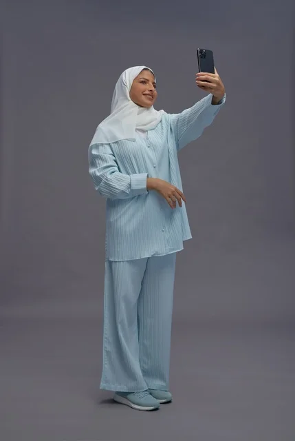 Saudi Woman Taking Selfie in Casual Blue Outfit