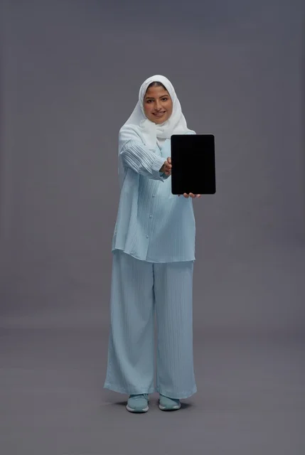 Saudi Woman with Tablet on Gray Background
