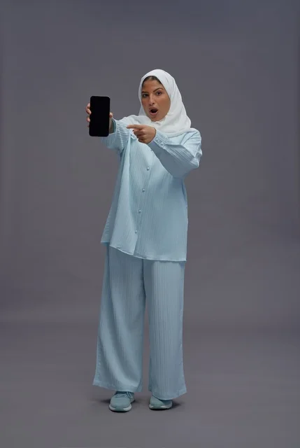 Surprised Saudi Woman Pointing at Smartphone Screen