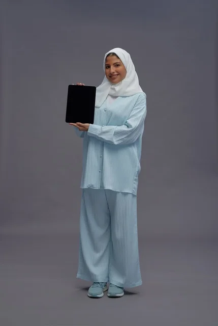 Saudi Woman with Tablet on Grey Background