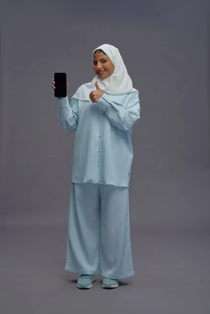 Saudi Woman with Smartphone Giving Thumbs Up