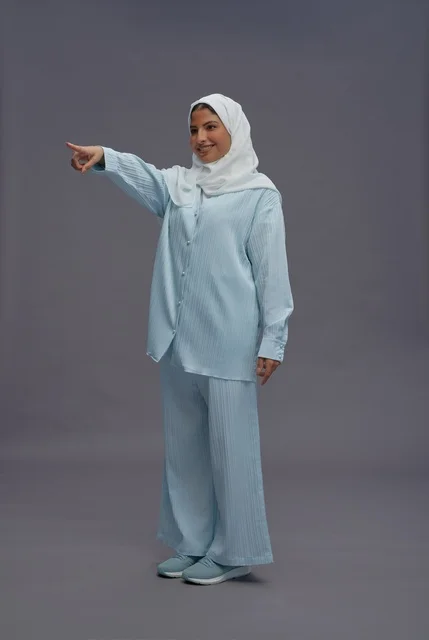 Saudi Woman in Blue Casual Wear Pointing Forward