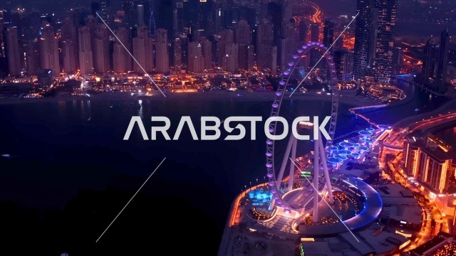 عين دبي وأفق دبي مارينا ليلاً لقطة جوية