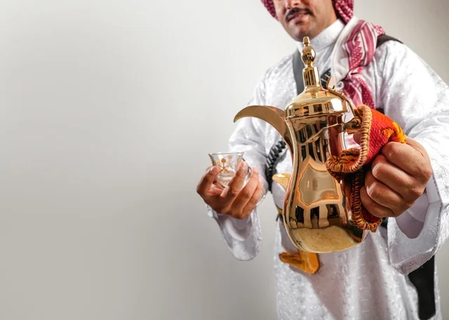 Saudi Man Holding Traditional Golden Coffee Dallah
