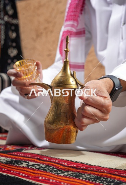 Saudi Man Holding Traditional Dallah Coffee Pot
