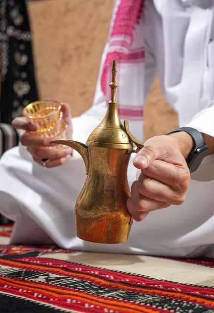 Saudi Man Holding Traditional Dallah Coffee Pot
