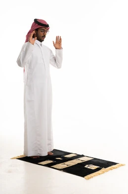 Saudi Man Performing Takbir on Prayer Mat