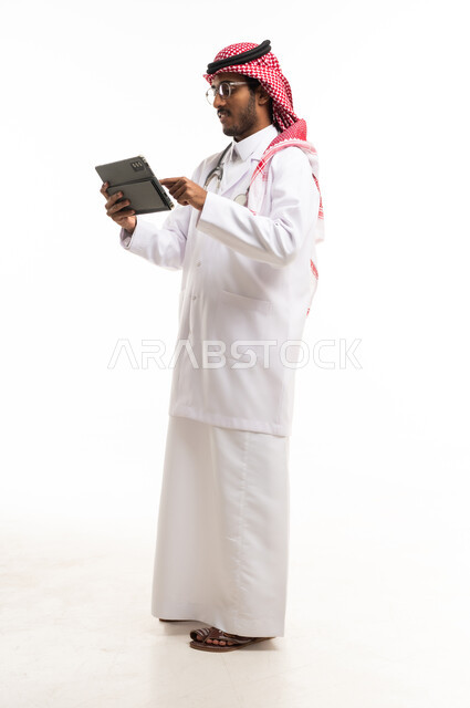 Saudi Male Doctor Using Tablet on White Background
