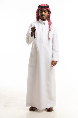 Saudi Man in Traditional Thobe Holding Prayer Beads