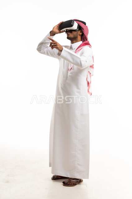 Saudi Man Using Virtual Reality Headset on White Background