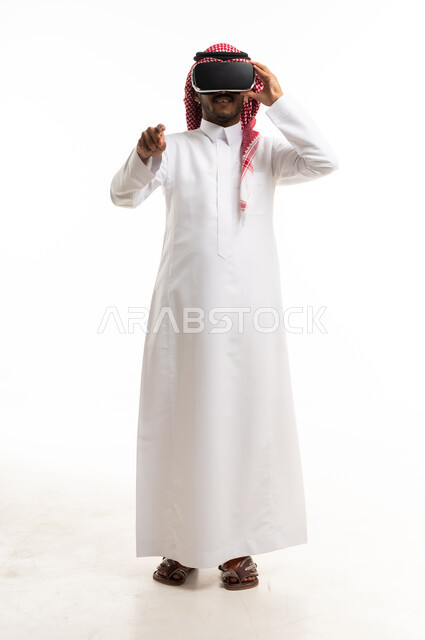 Saudi Man Using VR Headset and Gesturing in White Studio