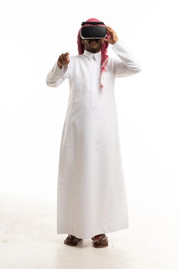 Saudi Man Using VR Headset and Gesturing in White Studio