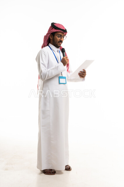 Saudi Man in Traditional Thobe Speaking into Microphone