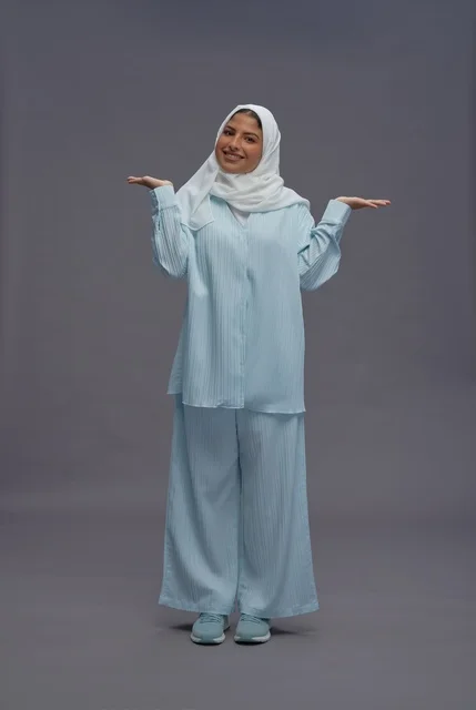 Saudi Woman in Modest Blue Outfit with Open Hands Saudi Woman in Modest Blue Outfit with Open Hands
