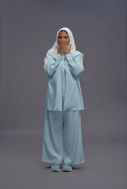 Surprised Saudi Woman in Blue Modest Clothing